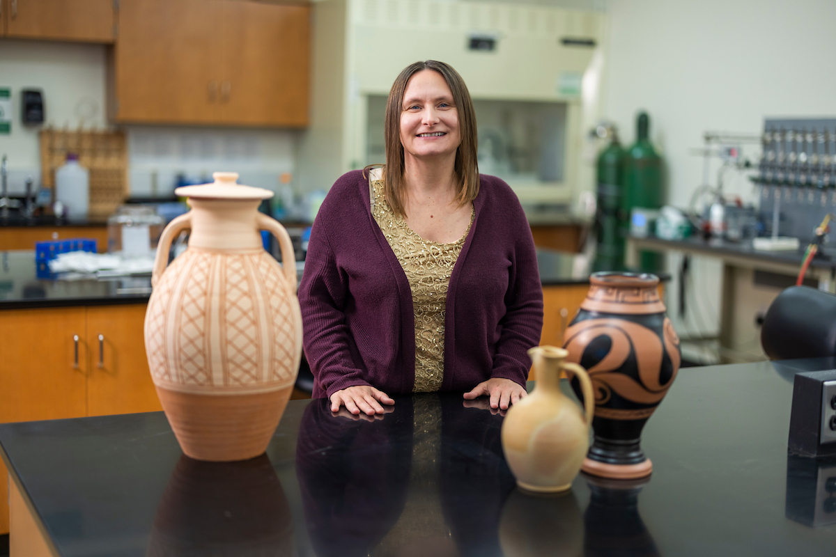 Julie Hoggarth stands alongside artifacts in her Baylor laboratory.
